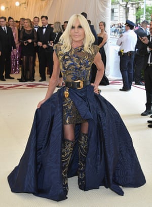 Designer and another of the Met Gala 2018 co-chairs Donatella Versace wears one of her own designs, an embroidered navy and gold mini-dress topped with a sweeping navy overskirt