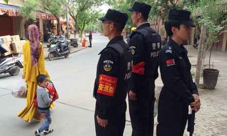 Police patrol the Old Town in Kashgar, to the west of Luopu county.