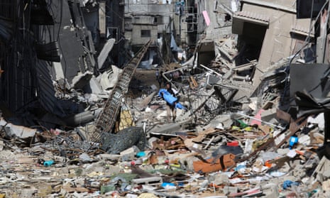 A Palestinian walks through destruction left by the Israeli offensive on Khan Younis on Friday.