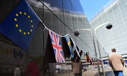 An European flag and a British flag stand next to each others outside the European Commission building, in Brussels