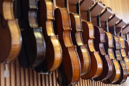 Violins hang on the wall in Martin Paul's workshop in Melbourne
