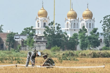 Soldiers inspect the debris of a missile at a field on the outskirts of Amritsar on 8 May.