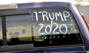 A dog waits in the car painted “TRUMP 20/20” in its rear window, while a voter casts his ballot in state and local elections in Barry Township, Schuylkill county, Pennsylvania, on 5 November 2019.