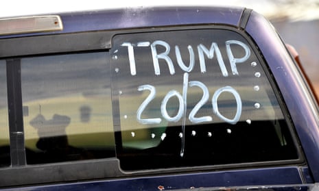 A dog waits in the car painted “TRUMP 20/20” in its rear window, while a voter casts his ballot in state and local elections in Barry Township, Schuylkill county, Pennsylvania, on 5 November 2019.