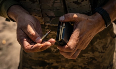 A Ukrainian soldier loads his AK-47 at a shooting range