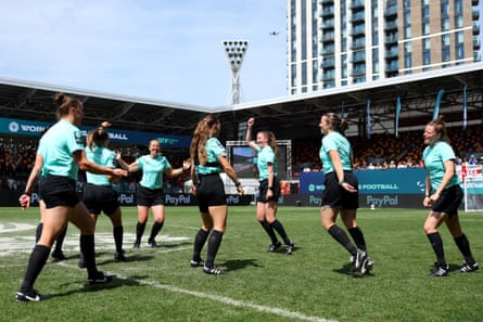 The officials perform their own walkout before the final