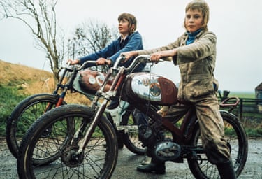 Edam, c. 1973. Two men on lightweight motorcycles stare into the camera