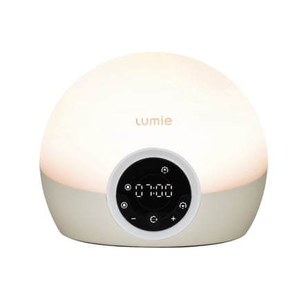 Lumie Bodyclock Spark 100 Wake up to Daylight Table Lamp on a bed side table.