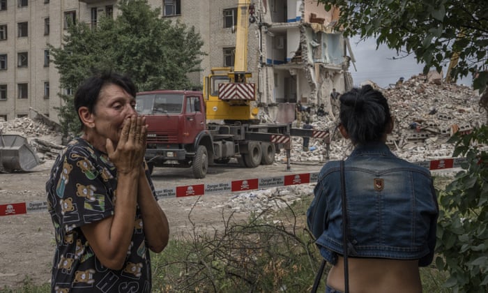 Iryna Shulimova, 59, weeps at the scene of the Russian rocket that hit an apartment residential block, in Chasiv Yar, Donetsk region, eastern Ukraine, that has left at least 15 people dead. (AP Photo/Nariman El-Mofty)