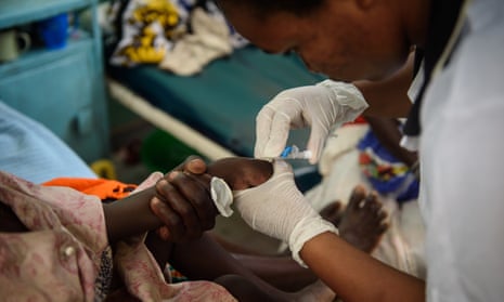 Nurse treating malaria patient
