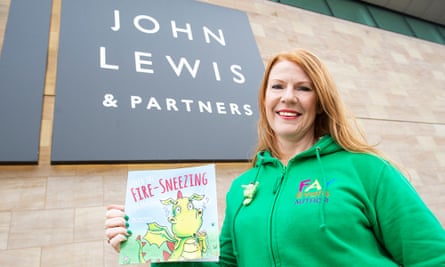 Fay Evans outside a branch of John Lewis with her book Fred the Fire-Sneezing Dragon