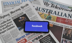Facebook blocks Australian users from viewing and sharing news<br>epa09020239 An illustration image shows a phone screen with the Facebook logo and Australian Newspapers at Parliament House in Canberra, Australia, 18 February 2021. Social media giant Facebook has moved to prohibit publishers and people in Australia from sharing or viewing Australian and international news content in response to Australia's proposed media bargaining laws. EPA/LUKAS COCH AUSTRALIA AND NEW ZEALAND OUT