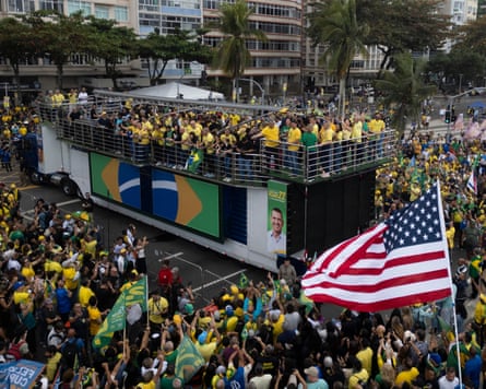 A giant US flag on a flagpole is flown near the stage at Bolsonaro's campaign launch event