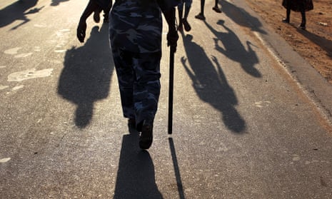 A police officer walks in a pro-independence march in Juba, South Sudan
