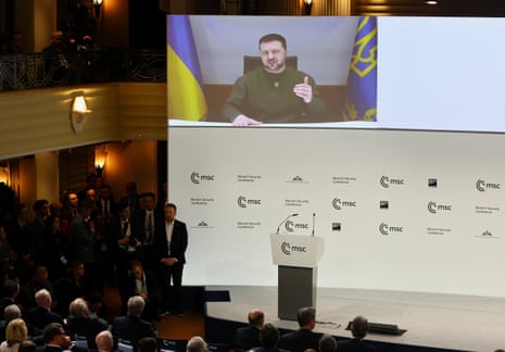 Ukrainian President Volodymyr Zelenskiy appears on the screen during the Munich Security Conference.