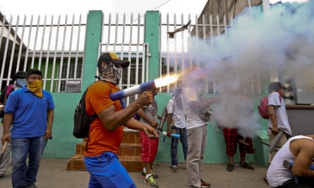 A masked protester shoots off his homemade mortar in the Monimbo neighborhood during clashes with police, in Masaya, Nicaragua.