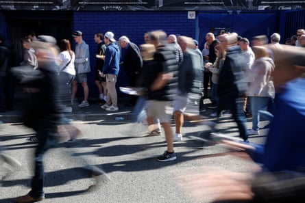People queuing up and rushing to get into the ground before kick-off for the Arsenal game