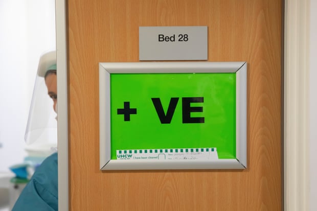 A ‘Covid positive’ sign on a doorway indicating that the patient within has tested positive.