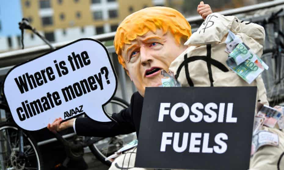 A person wearing a Boris Johnson mask at a Cop26, protest, Glasgow, 12 November 2021.