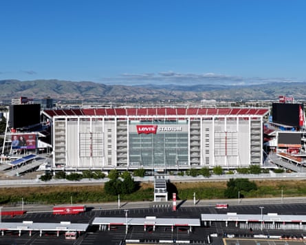 An exterior view of the stadium with mountains behind.