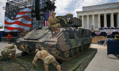 An army soldier hops out of a Bradley fighting vehicle after moving it into place by the Lincoln Memorial in Washington DC, on 3 July.