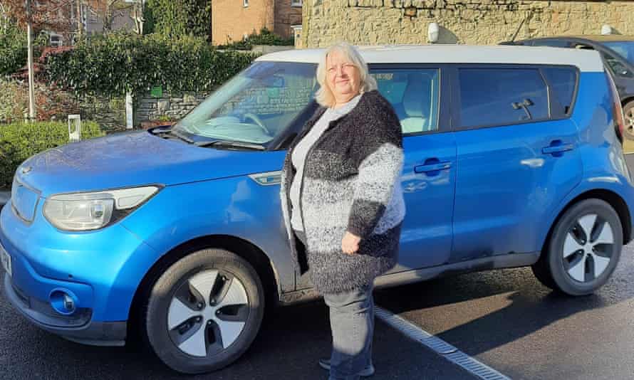 Sue Peachey, 57, with her new electric car, which she bought after attending the UK's first climate assembly