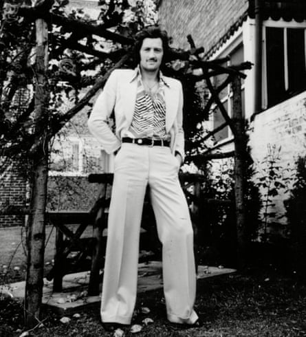 Black and white photo of Frank Worthington dressed in a light-coloured wide-legged suit.
