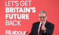 Keir Starmer pictured from the waist up, giving a thumbs-up sign with his left hand. He is wearing a shirt, jacket and tie. He stands in front of a large red backdrop featuring the words 'Let's get Britain's future back' and the Labour party logo.