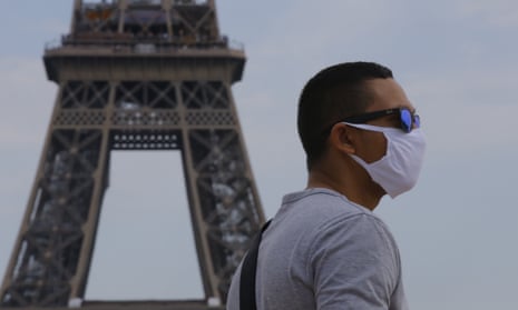 Man wearing face mask in front of Eiffel Tower