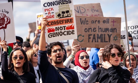Demonstrators hold signs calling for ceasefire and saying 'we are all one human family'
