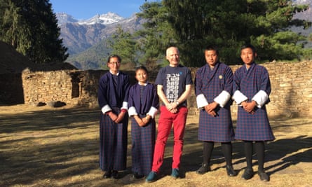 students and author in front of mountain backdrop