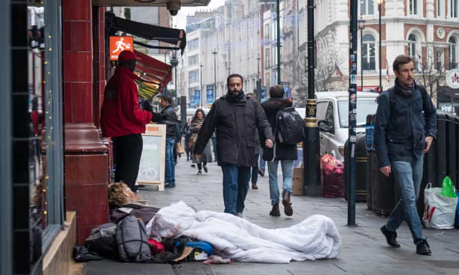 A man sleeping rough outside Leicester Square station in London. 