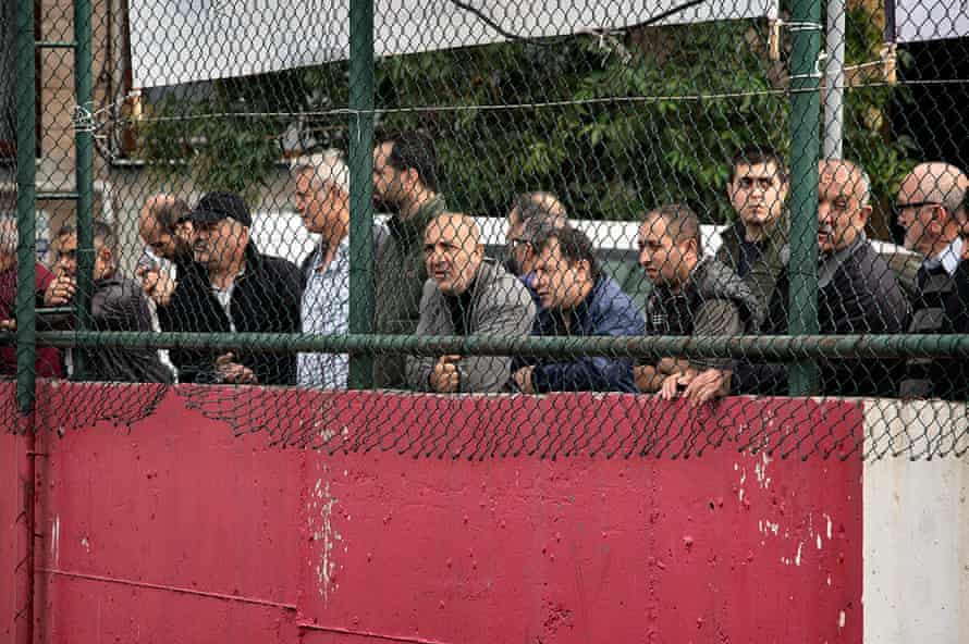 Turkish soccer fans watching the match from the outside of the Feriköy Stadium.