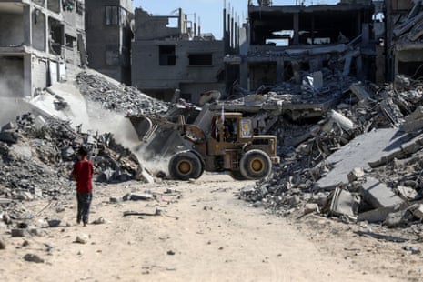 A heavy machinery removes debris from a street in Gaza City following a period of Israeli airstrikes.