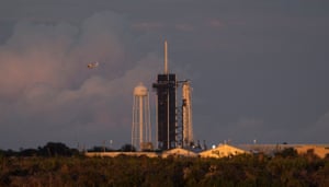 A NASA helicopter flying over a SpaceX Falcon 9 rocket