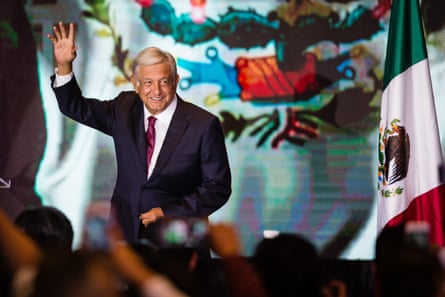 a man in a suit waving to a crowd of people