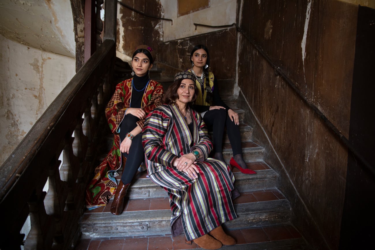 Yasamin Yarmal, a very well-known Afghan actress sits on a flight of stairs with her two daughters.