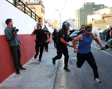 A man attempting to escape the police, on Ceuta, following the mass migration, 2 August 2026.