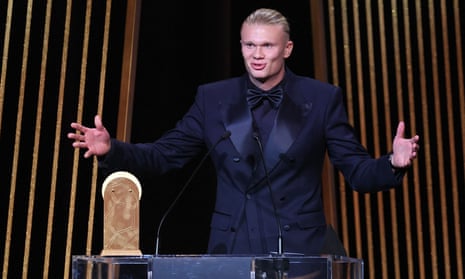 Manchester City's Erling Haaland gestures on stage as he receives the Gerd Muller Trophy for Best Striker during the 2023 Ballon d'Or France Football award ceremony.