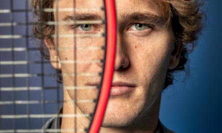 A close-up of Alex Zverev's face with the left half obscured by a tennis racquet