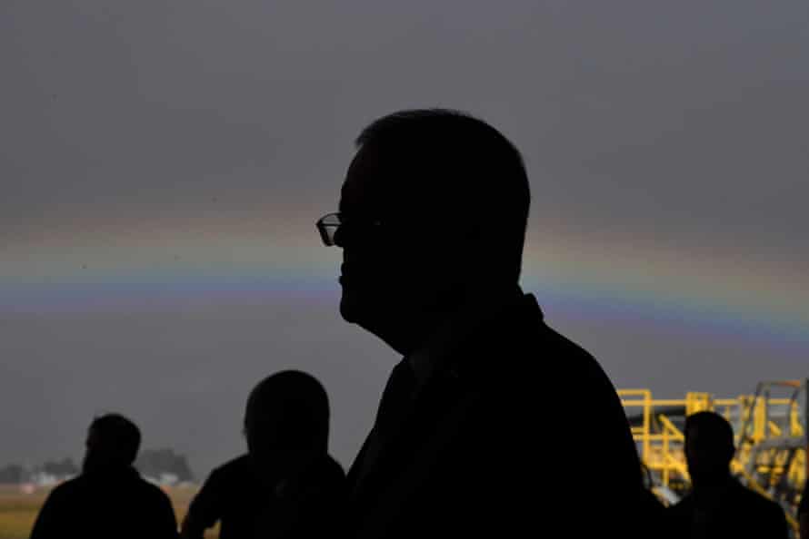 Prime minister Scott Morrison with a rainbow at a press conference at the Sikorsky Hangar at HMAS Albatross in Nowra, in the seat of Gilmore