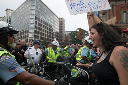 A counter protester remonstrates with a police motorcyclist who was escorting the nationalists.