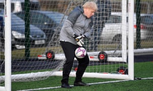 BRITAIN-POLITICS-EU-BREXIT-VOTE<br>Britain's Prime Minister Boris Johnson tries to save a shot during a warm up before a girls football match while on the campaign trail in Cheadle Hulme, northwest England on December 7, 2019. - Britain will go to the polls on December 12, 2019 to vote in a pre-Christmas general election. (Photo by TOBY MELVILLE / POOL / AFP) (Photo by TOBY MELVILLE/POOL/AFP via Getty Images)
