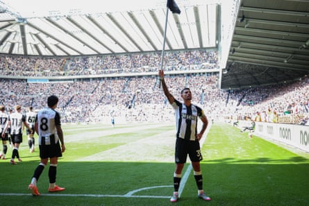 Bruno Guimarães raises the corner flag after scoring Newcastle’s late second goal.