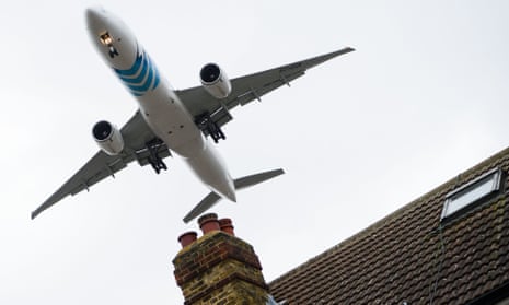An aircraft flying over houses in Hounslow as it prepares to land at London Heathrow airport.