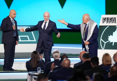 Palestinian FA president Jibril Rajoub, right, walks away from Gianni Infantino after refusing to stand together with Israel FA vice-president Basim Sheikh Suliman