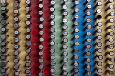 Columns of numbered buttons or hooks on a board of faded yellow, red, green and blue