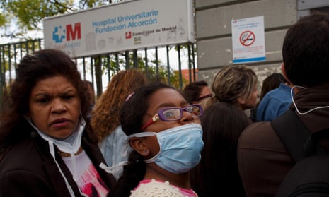People wear protective masks before they enter Hospital Fundacion Alcorcon where a Spanish nurse tested positive for the Ebola virus in Alcorcon, Spain.
