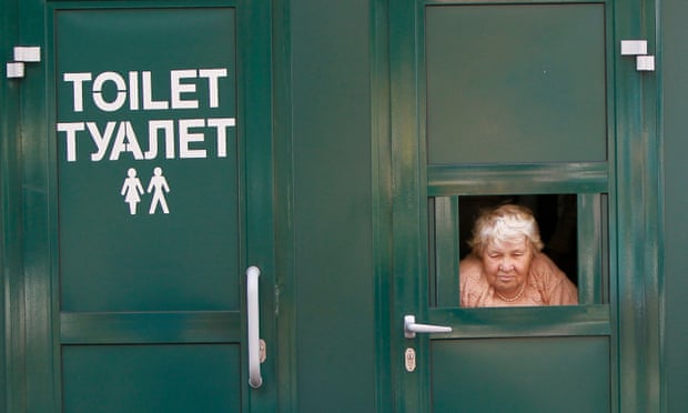 A cashier awaits clients as she sells tickets to a public toilet in central Kiev.