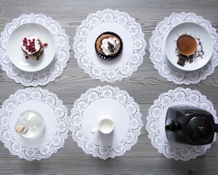 Teapot and plates of dessert on lace doiliesG1M2DX Teapot and plates of dessert on lace doilies